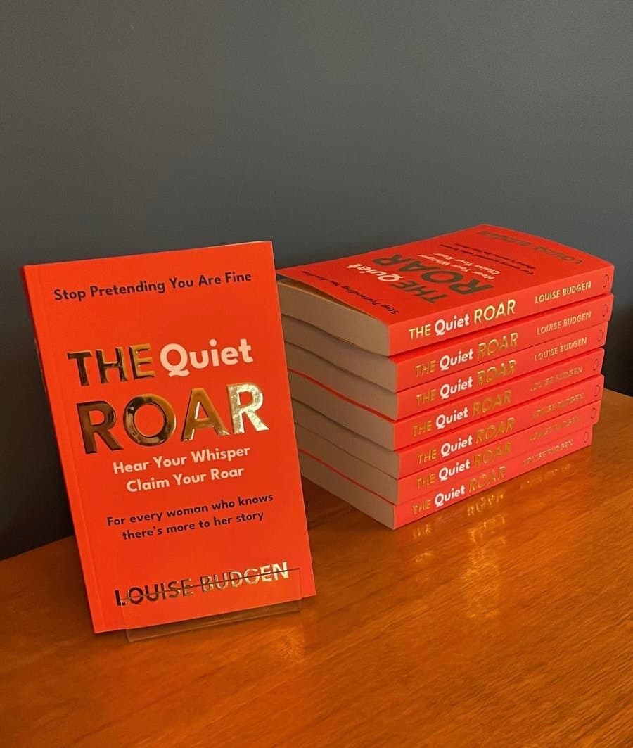 Stacked copies of The Quiet Roar by Louise Budgen