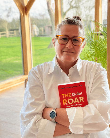 Louise Budgen holding a copy of The Quiet Roar